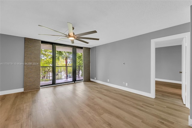 unfurnished room with a textured ceiling, light hardwood / wood-style flooring, and ceiling fan