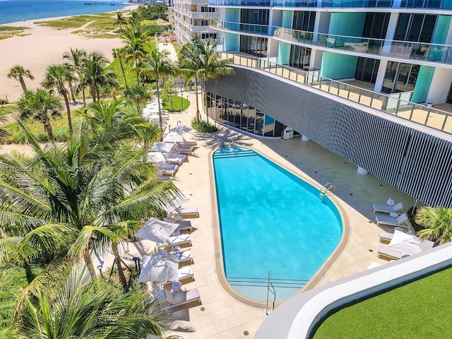 view of swimming pool with a water view and a patio