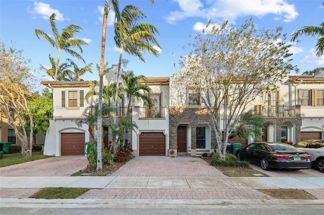 view of front of home with a balcony and a garage