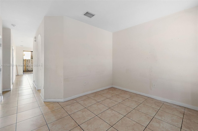 spare room featuring light tile patterned floors