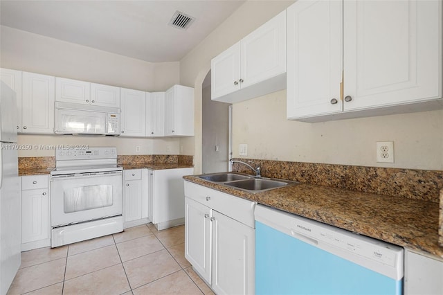 kitchen featuring white cabinetry, sink, light tile patterned flooring, and white appliances