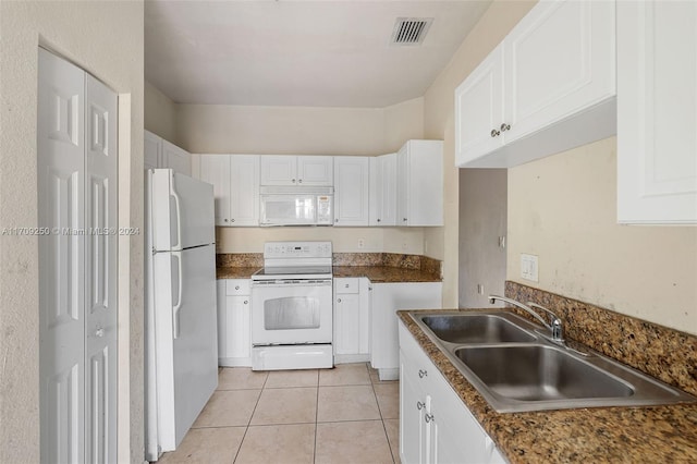 kitchen featuring white cabinets, light tile patterned floors, white appliances, and sink