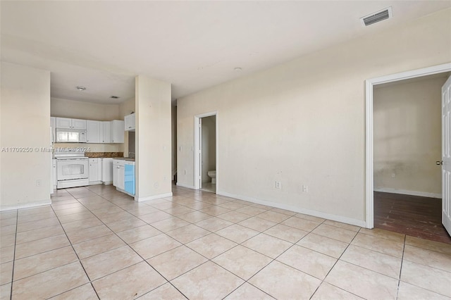 unfurnished living room featuring light tile patterned floors