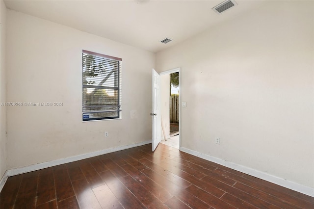 unfurnished room featuring dark hardwood / wood-style flooring