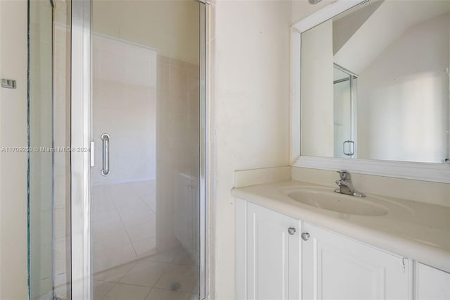 bathroom featuring tile patterned floors, vanity, and walk in shower