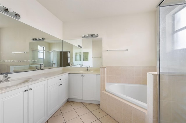 bathroom featuring tile patterned floors, plus walk in shower, and vanity