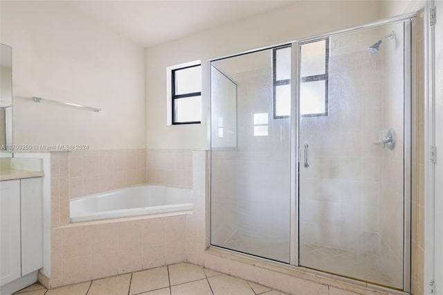 bathroom with tile patterned flooring, vanity, and independent shower and bath