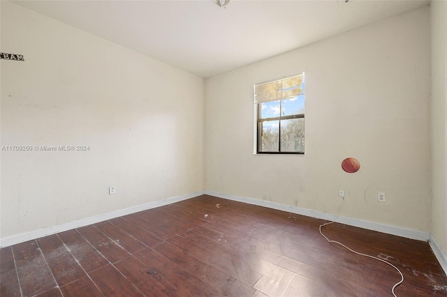 spare room featuring dark wood-type flooring