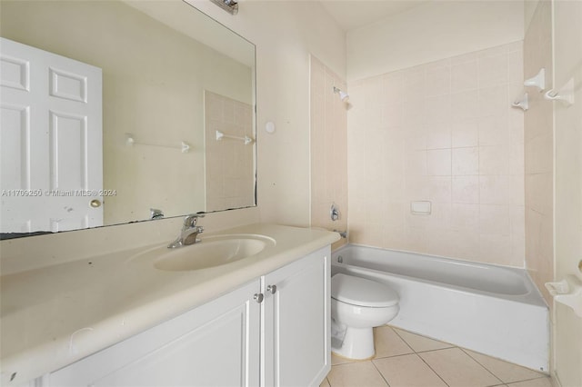 full bathroom with tile patterned floors, tiled shower / bath, vanity, and toilet