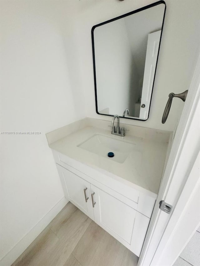 bathroom with wood-type flooring and vanity