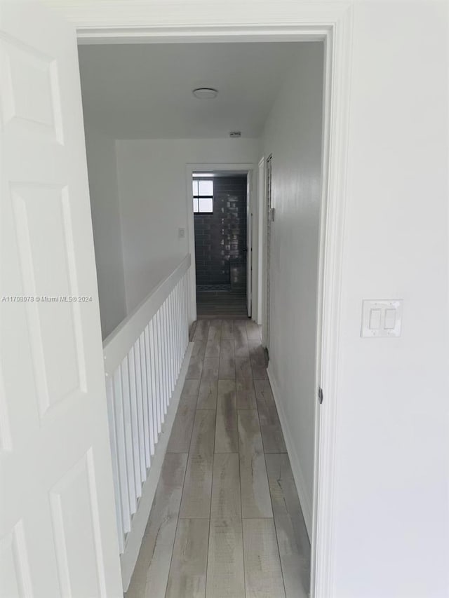 hallway with light hardwood / wood-style floors