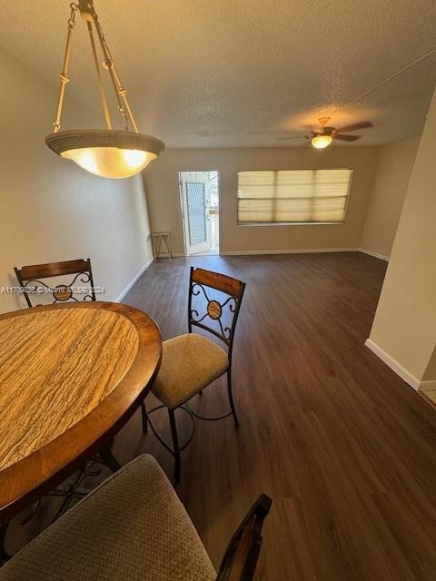 dining room featuring a textured ceiling, ceiling fan, and dark hardwood / wood-style floors