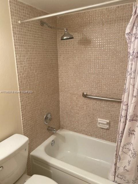 bathroom with toilet and shower / bath combo with shower curtain