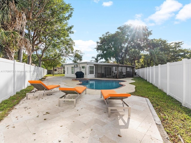 view of swimming pool with a sunroom and a patio