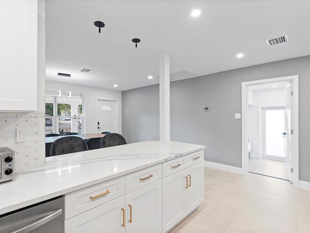 kitchen with dishwasher, light stone counters, white cabinetry, and hanging light fixtures