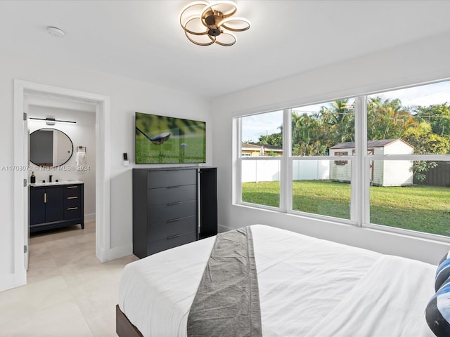 bedroom with ensuite bathroom and sink