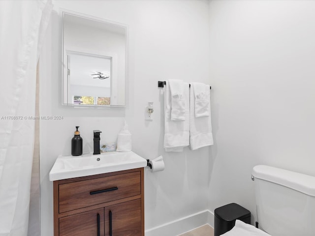 bathroom featuring vanity and toilet