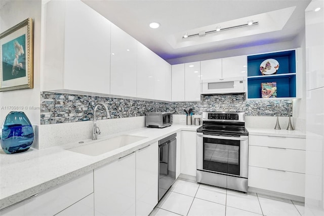 kitchen with white microwave, a sink, stainless steel range with electric cooktop, black dishwasher, and modern cabinets