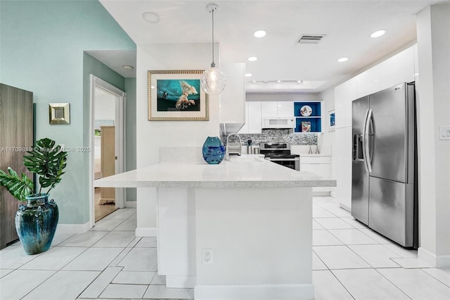 kitchen with a peninsula, light tile patterned flooring, modern cabinets, and appliances with stainless steel finishes