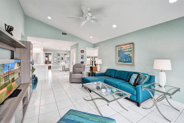 living room with ceiling fan, light tile patterned floors, and vaulted ceiling