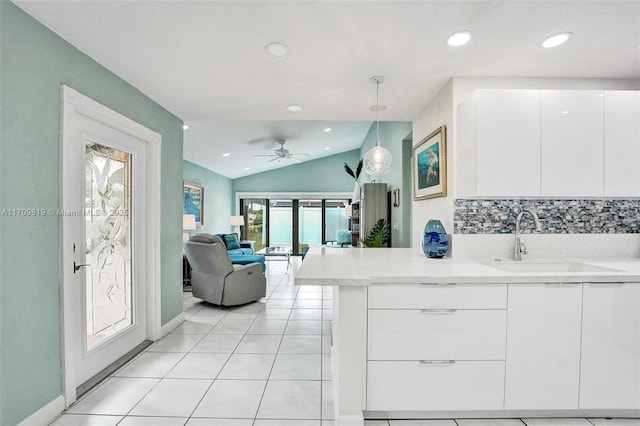 kitchen with light countertops, white cabinets, and a sink