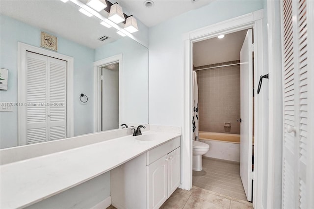 full bathroom featuring tile patterned floors, toilet, shower / bath combo, a closet, and vanity