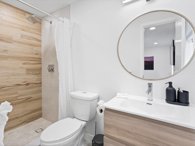 bathroom with curtained shower, vanity, and toilet