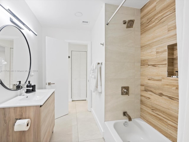 bathroom featuring tile patterned floors, vanity, and tiled shower / bath