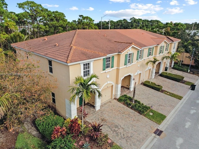 mediterranean / spanish-style house with a garage