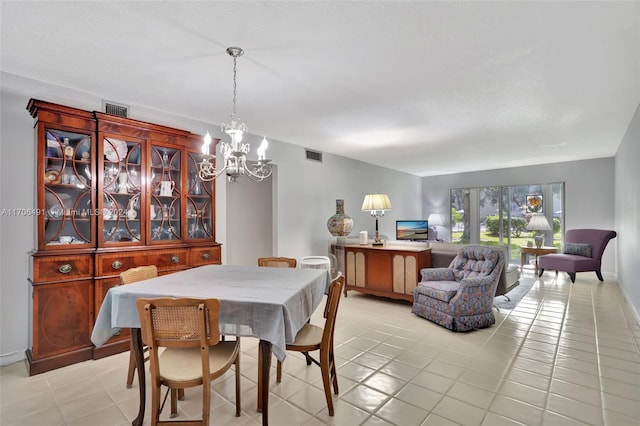 tiled dining space with an inviting chandelier