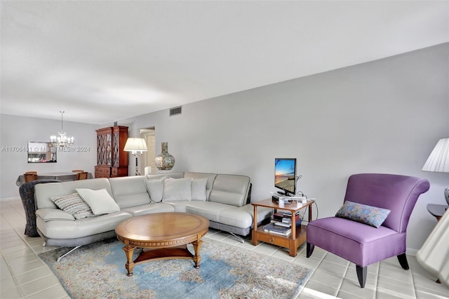 living room with a chandelier and light tile patterned floors