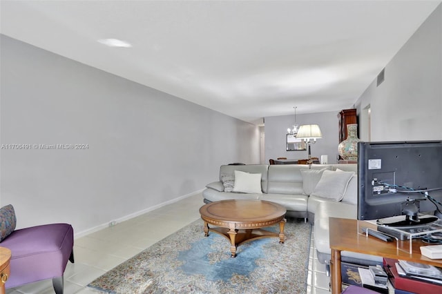 living room with an inviting chandelier and light tile patterned flooring