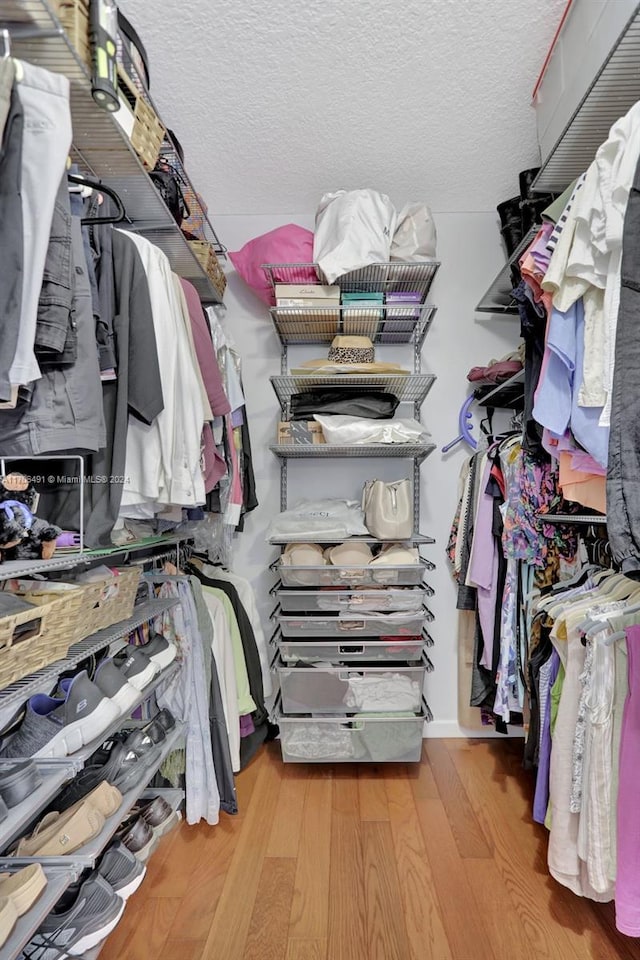 spacious closet with light hardwood / wood-style floors