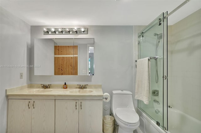 full bathroom with vanity, enclosed tub / shower combo, and toilet