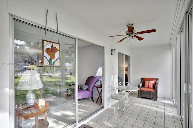 sunroom featuring ceiling fan