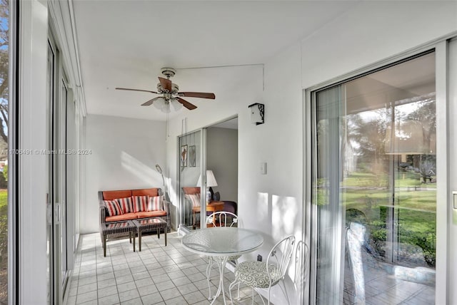 sunroom / solarium featuring ceiling fan