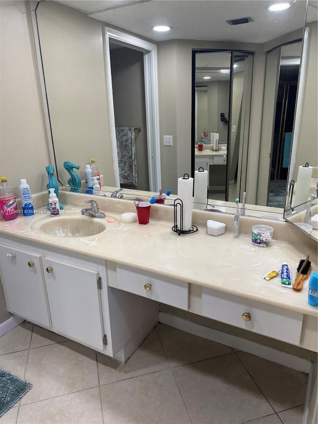 bathroom with tile patterned floors and vanity