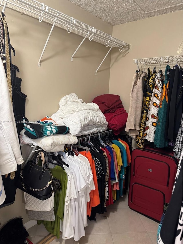 spacious closet featuring light tile patterned flooring