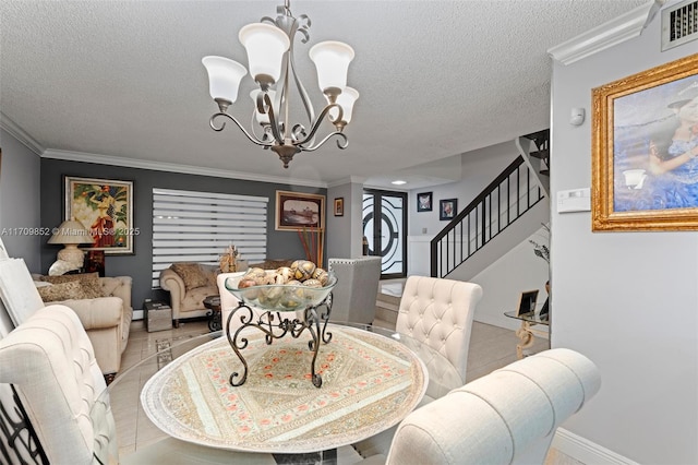 dining space featuring visible vents, ornamental molding, a textured ceiling, a chandelier, and stairs