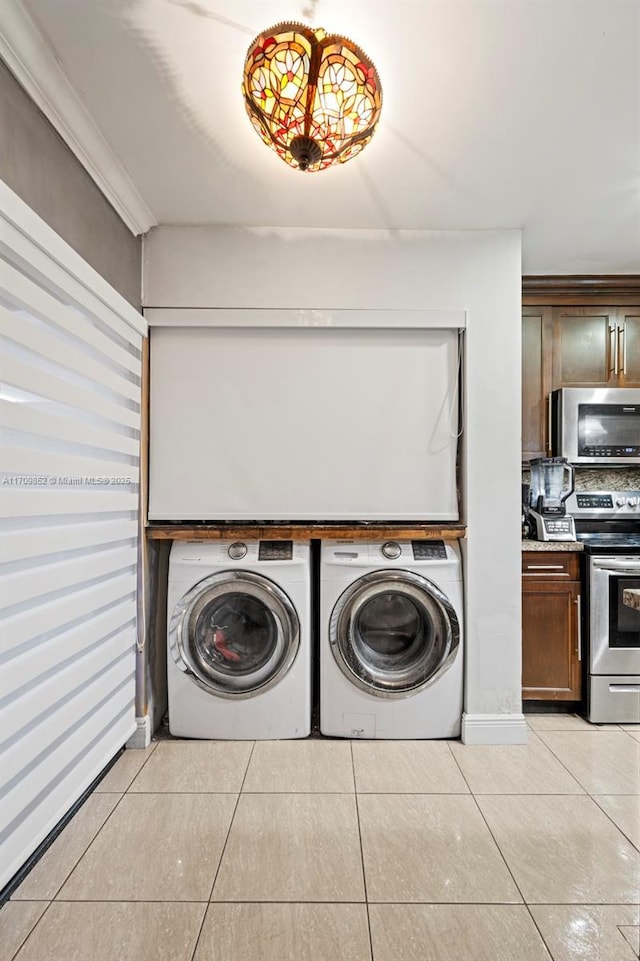 laundry room featuring laundry area, light tile patterned flooring, and independent washer and dryer