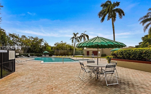 pool featuring a patio area and fence