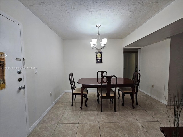 tiled dining space with a chandelier and a textured ceiling