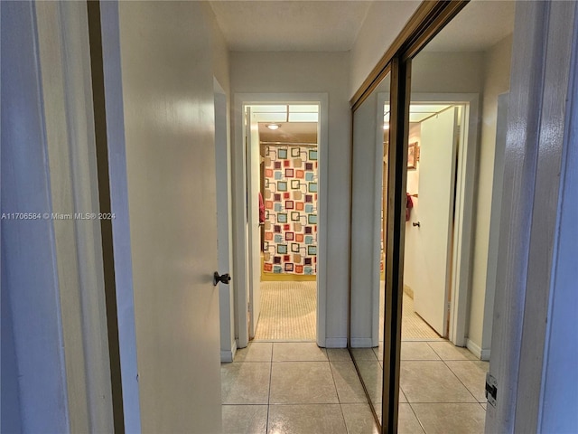 hall featuring light tile patterned floors