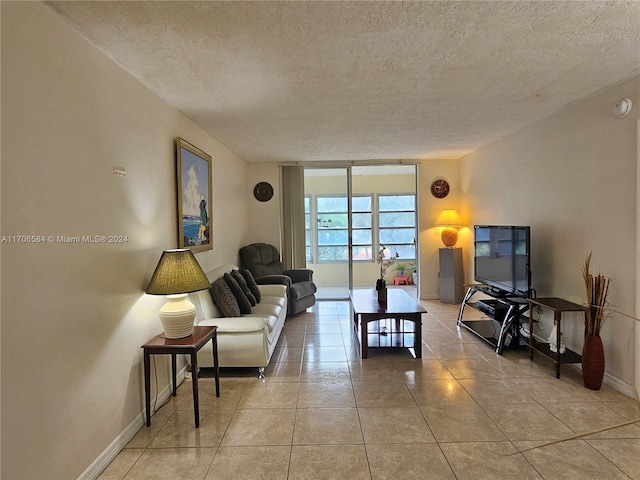 tiled living room featuring a textured ceiling