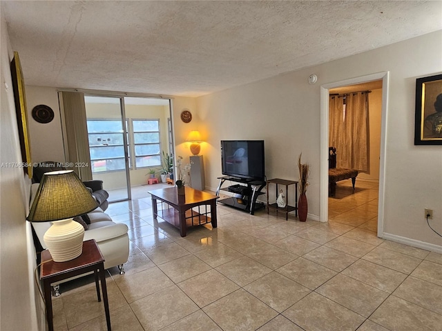 living room with light tile patterned flooring and a textured ceiling