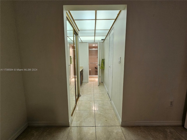 hallway featuring light tile patterned floors