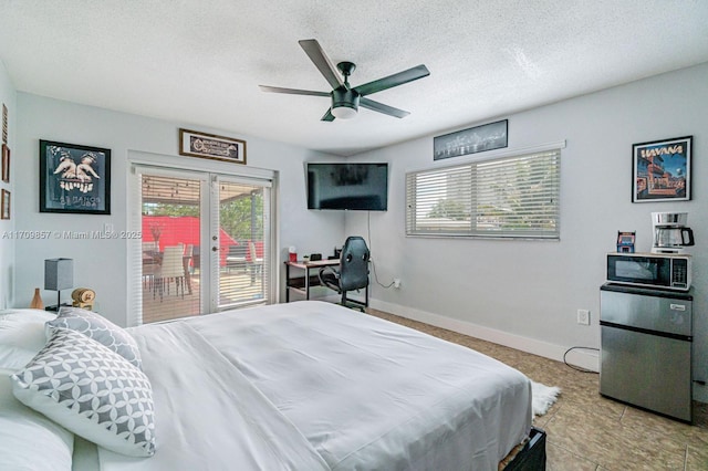 bedroom with access to outside, multiple windows, ceiling fan, and a textured ceiling