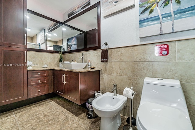 bathroom featuring vanity, a bidet, tile walls, and toilet