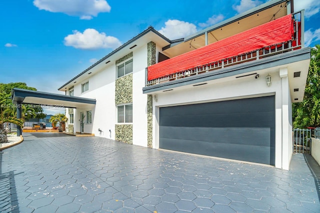 exterior space with a garage and a balcony