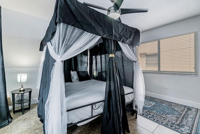 tiled bedroom featuring ceiling fan and a textured ceiling